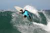 A photograph of a surfer riding a wave