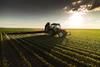 An image showing a tractor spraying crops