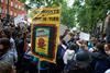 An image showing a protester holding a placard reading 'Glyphosate : license to kill'