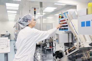 Image showing woman operating machine making medical equipment