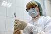 A photo of a medical worker preparing a syringe