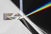 An image showing a prism breaking up a beam of white light into its rainbow-coloured constituents