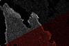 An image of a blob with the top half pixellated in grey scale and the bottom sharper in red and black