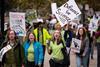 People on a protest march holding placards that read Defiance for Science and Scientists Strike Back