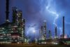 Lightning bolt on top of oil refinery