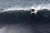 A surfer riding a very large wave